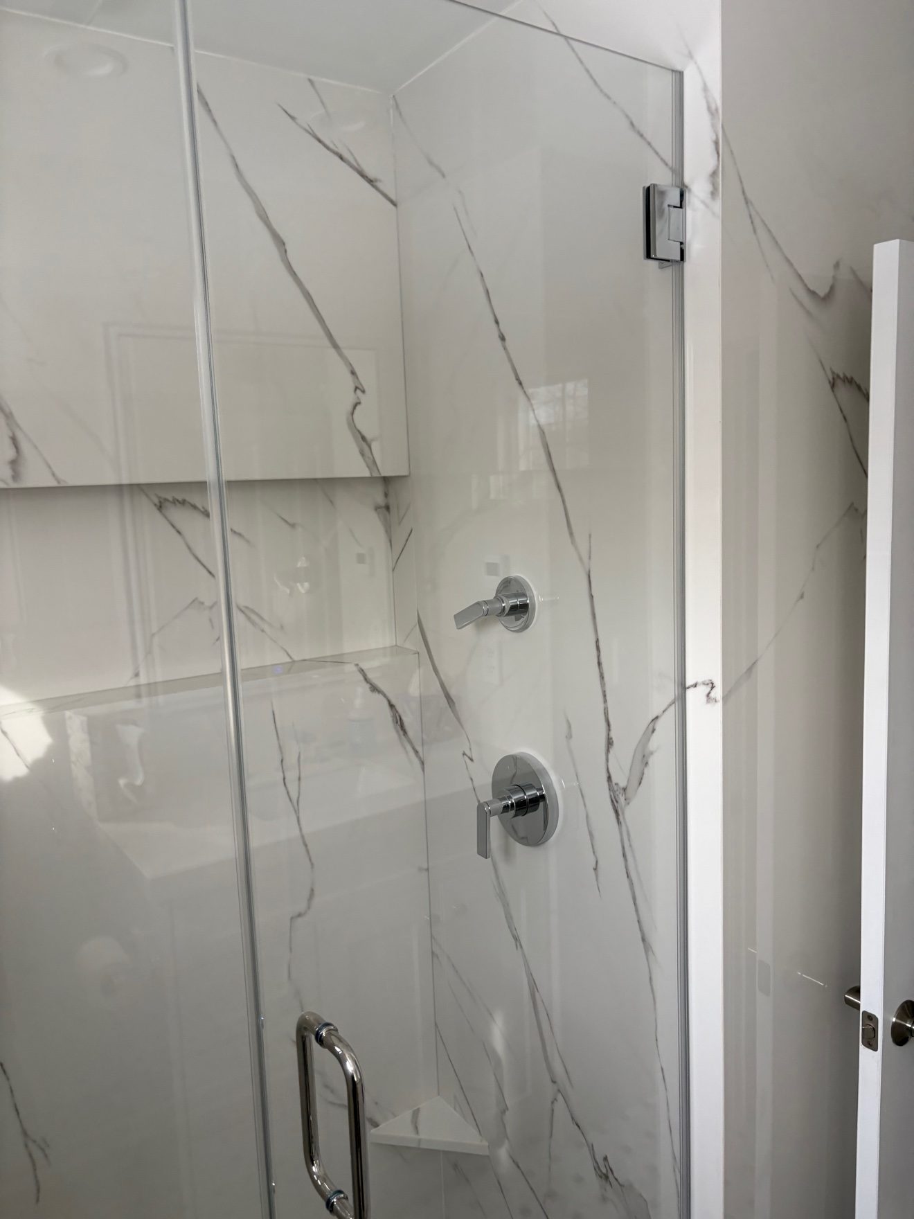 Bathroom remodel — glass shower and controls.