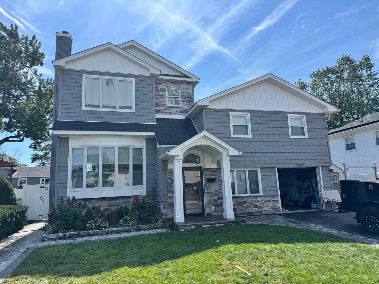 Home exterior — siding, stone veneer, and entry.